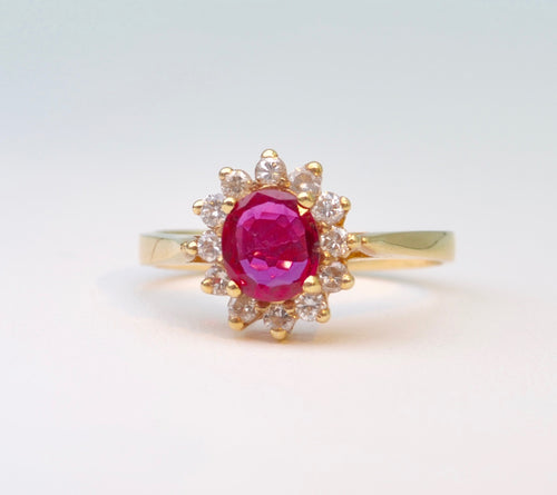 14K yellow gold ring with one center Ruby and 12 surrounding Diamonds