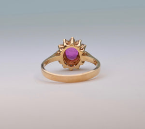 14K yellow gold ring with one center Ruby and 12 surrounding Diamonds