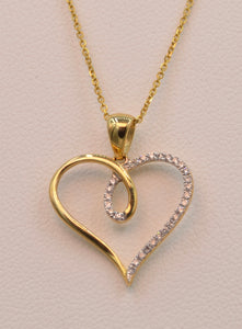 14K yellow gold heart-shaped pendant, half set with diamonds