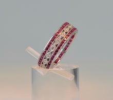 18K white gold wedding band with 2 rows of Rubies framing one center row of diamonds