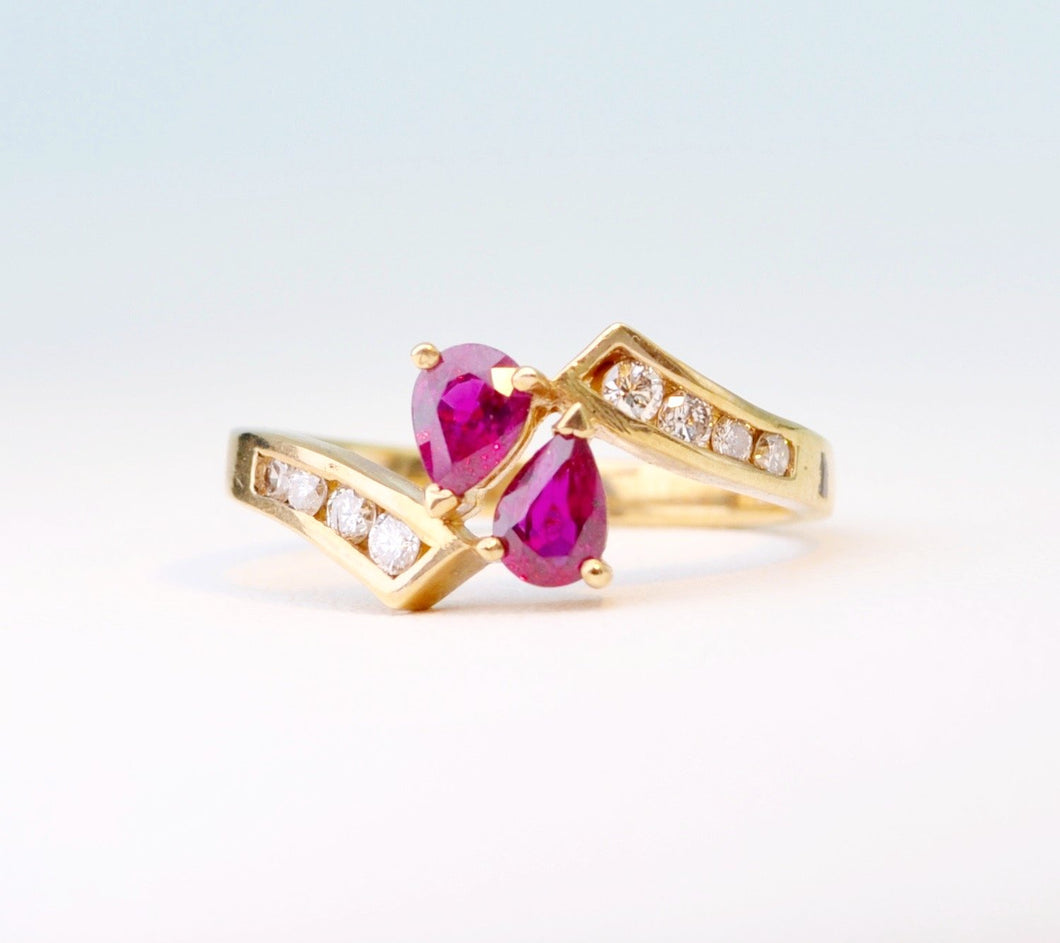 14K yellow gold ring with 2 pear-shaped Rubies and 8 side Diamonds