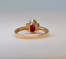 14K yellow gold ring with one center oval Ruby and four side Diamonds