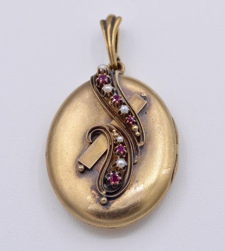 14K yellow gold locket with photo inside decorated with Rubies and seed pearls