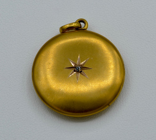 14K yellow gold locket with one diamond star burst on front